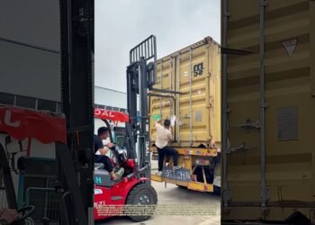 Forcing a Filled Container Close: Forklift Tines Cling the Door Whilst Staff Protected the Latch